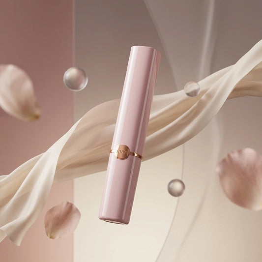 Elegant naked pink Xindari lipstick style bullet massager floating among silk, petals, and transparent bubbles