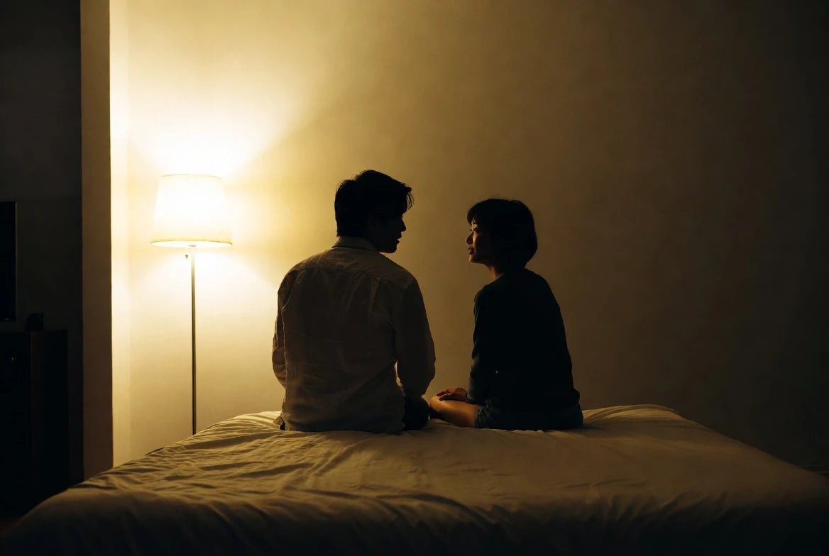 Couple having a calm bedside conversation to rebuild intimacy and connection