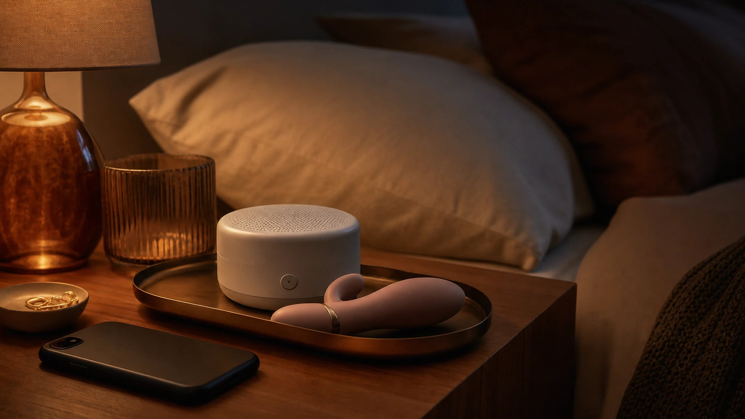 Phone-free bedtime setup with amber light, white noise machine, and discreet silicone massager