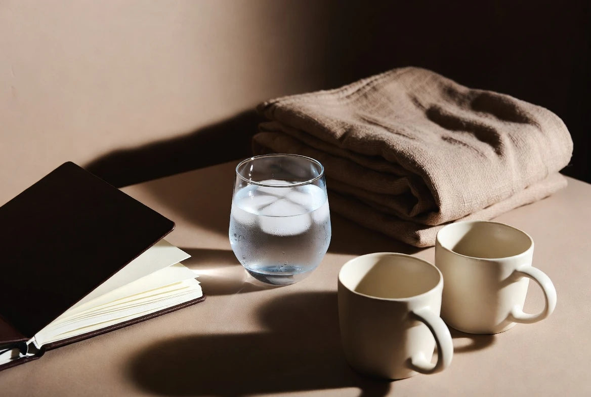 Bedside ritual items and journal representing an intimacy reset checklist for couples