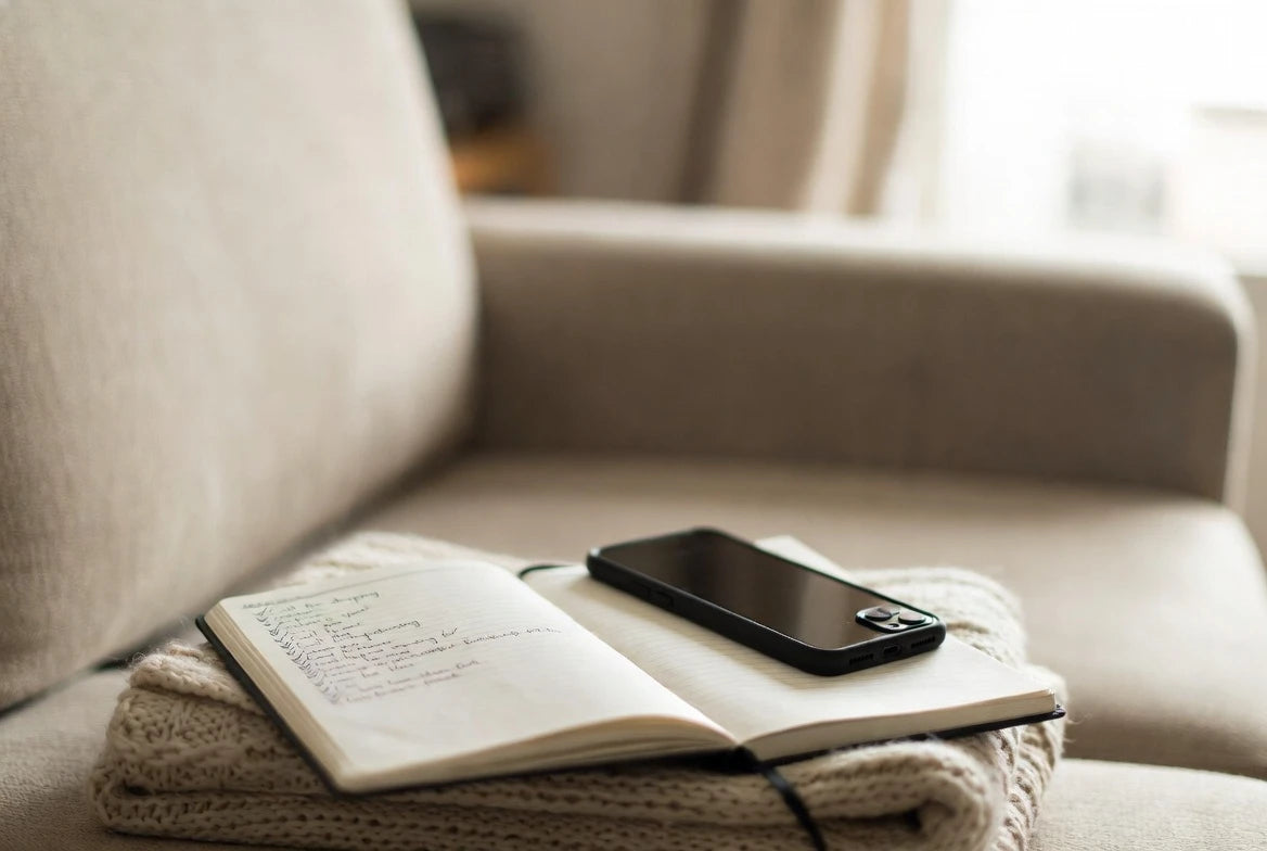 Notebook checklist and silent phone used to evaluate intense dating behavior calmly