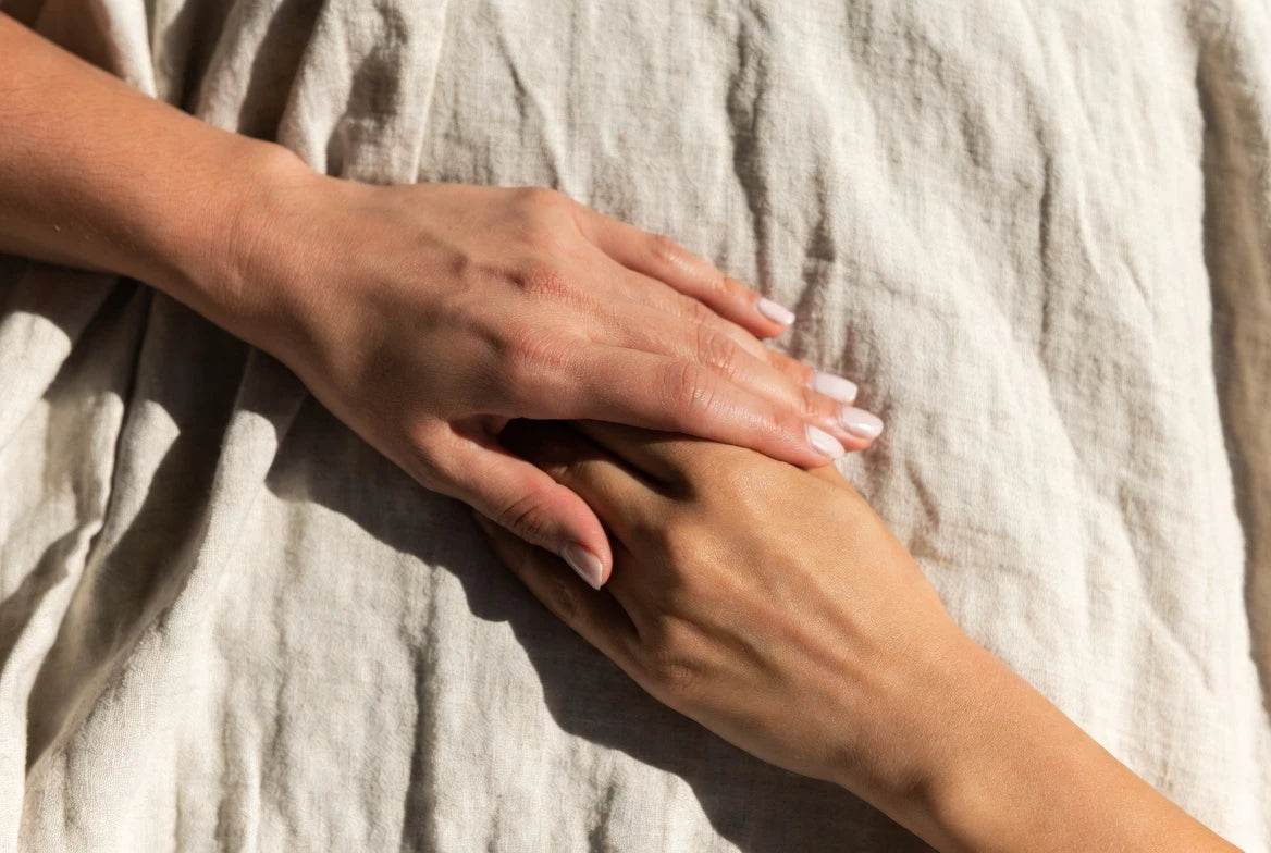 Two hands gently clasped together — representing the physical touch love language and emotional connection