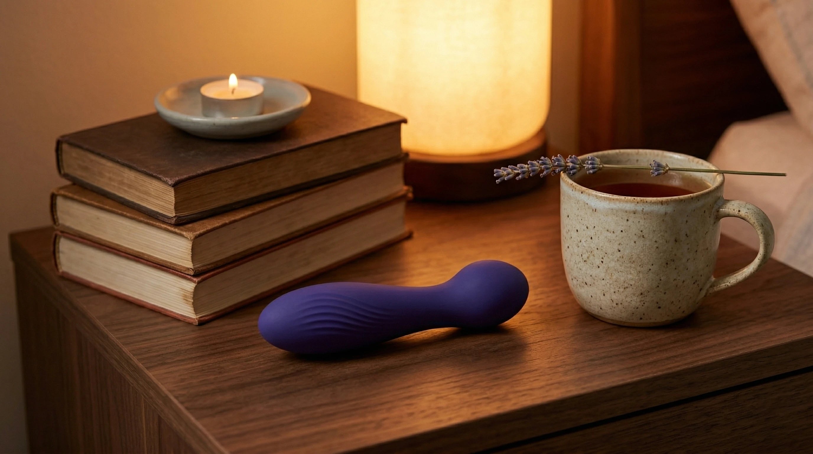 Purple vibrator on nightstand alongside evening self-care ritual — Xindari wellness aesthetic