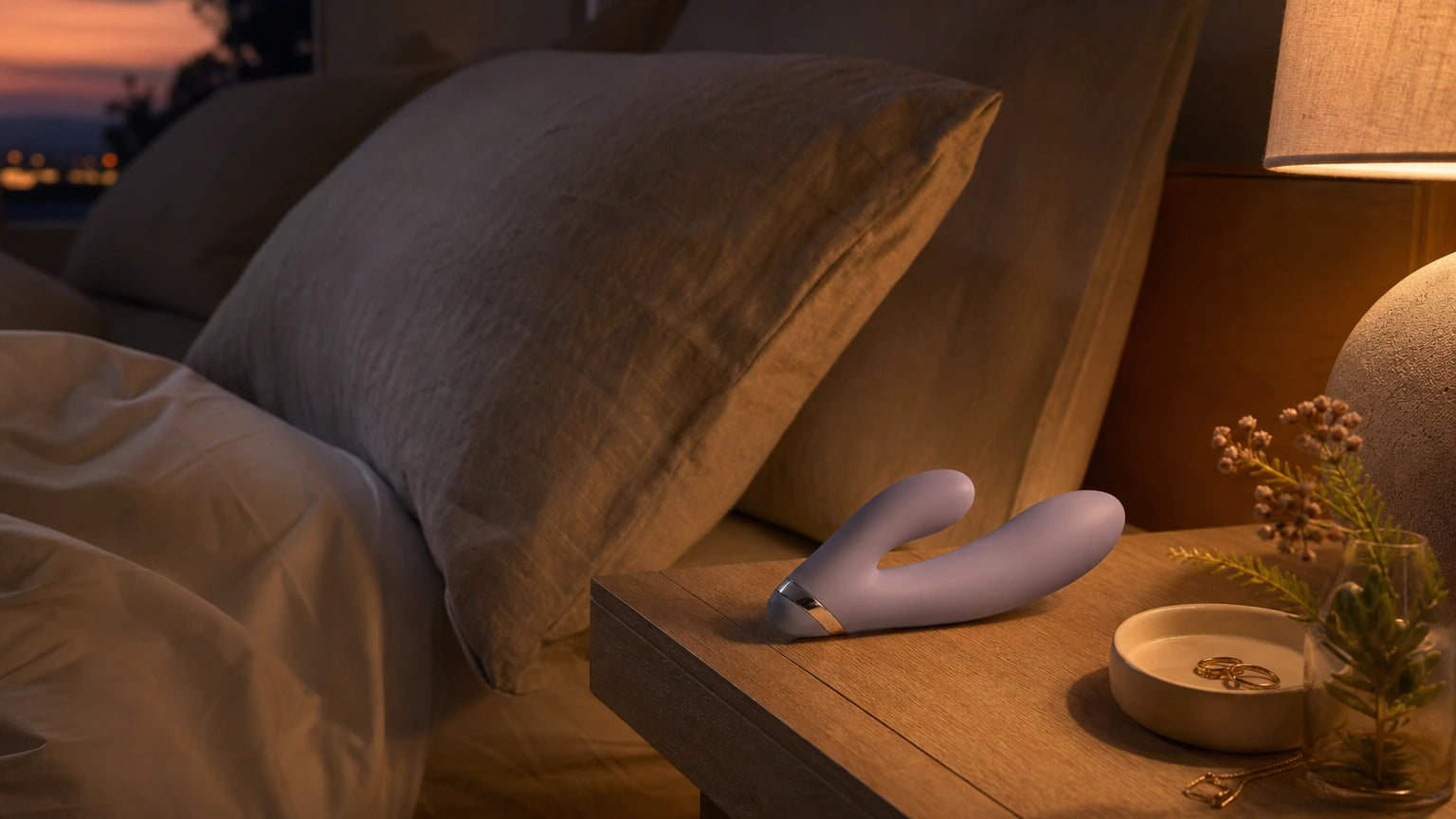 Discreet silicone massager on a nightstand styled as part of an adult evening grounding and self-care ritual
